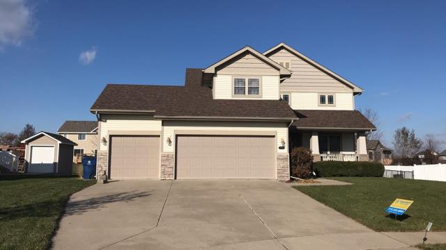We completed a comprehensive roofing overhaul on this Grimes, IA home, installing new shingles and repairing a damaged section of siding to provide a seamless, weather-tight finish.