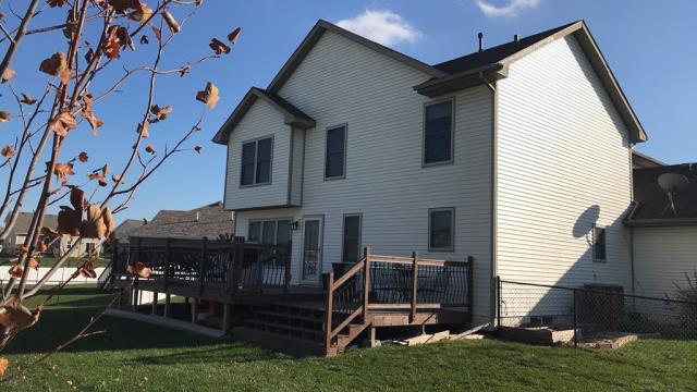 We completed a comprehensive roofing overhaul on this Grimes, IA home, installing new shingles and repairing a damaged section of siding to provide a seamless, weather-tight finish.