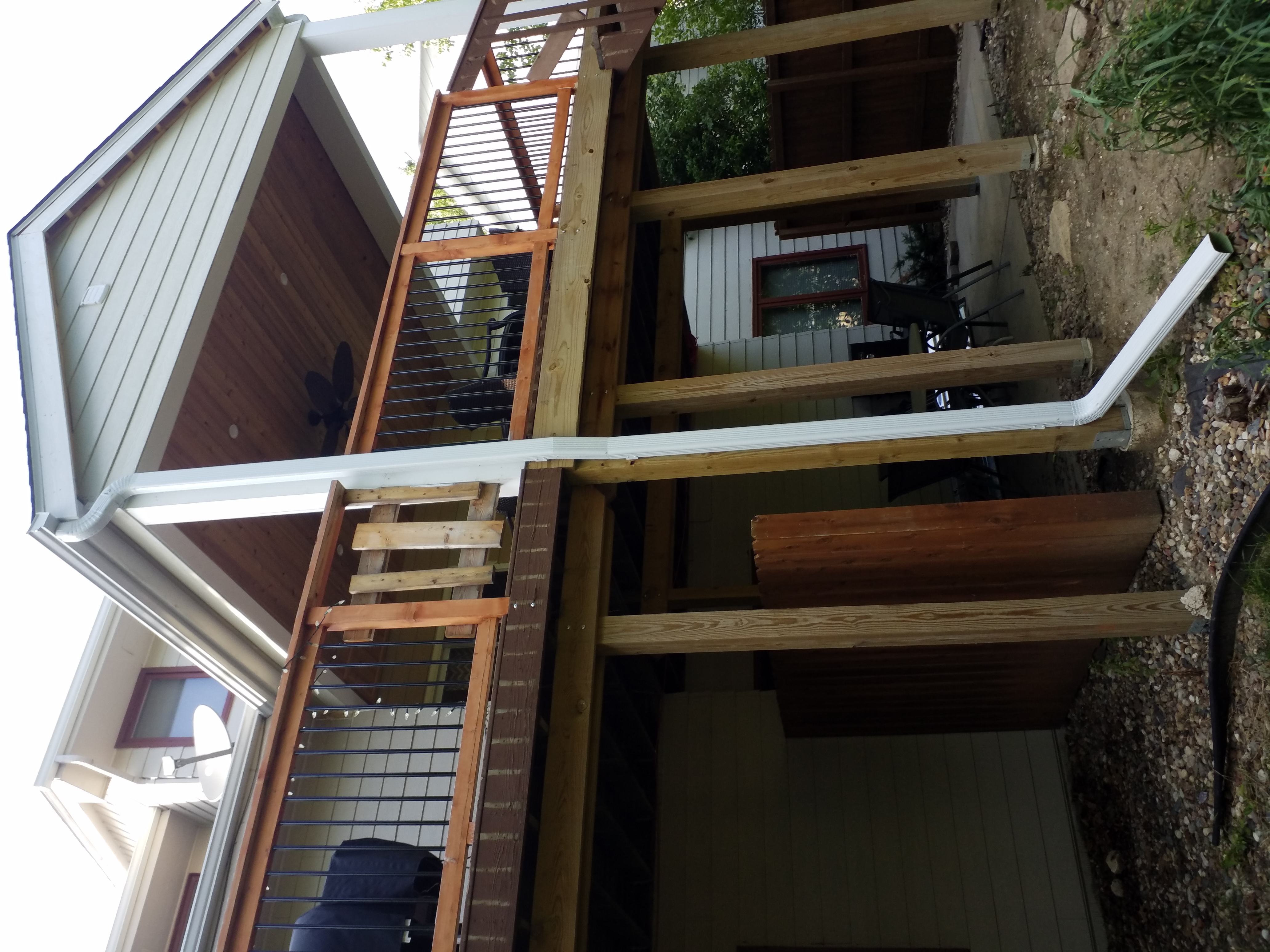 We installed new gutters and downspouts on the porch of this Clive, IA home to improve drainage and properly direct water away from the structure.