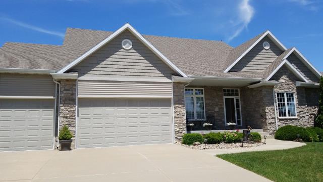 A new roof and gutter system were installed on this Johnston, IA home, improving weather protection and providing reliable water drainage for years to come.