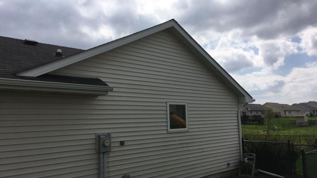 We completed roofing and siding repairs on this home in Ames, IA, replacing damaged shingles, addressing roof leaks, and installing new siding panels to restore the home's exterior and provide lasting protection against the elements.