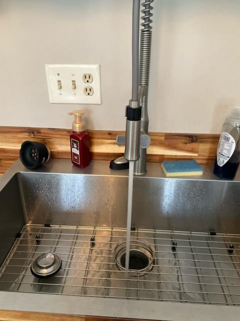 Diagnose low water pressure at kitchen sink faucet.