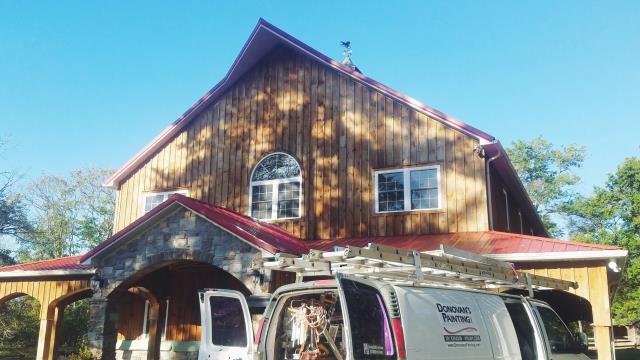 using hvlp spray gun & roller to stain the exterior of this beautiful barn on Watersedge Farm