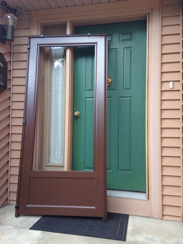 Worcester, MA - Renewal by Andersen Boston installing a storm door Worcester, MA - Renewal by Andersen Boston installing a storm door