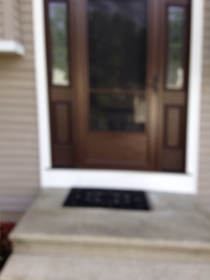 Shrewsbury, MA - Renewal by Andersen Boston inspecting storm door Shrewsbury, MA - Renewal by Andersen Boston inspecting storm door