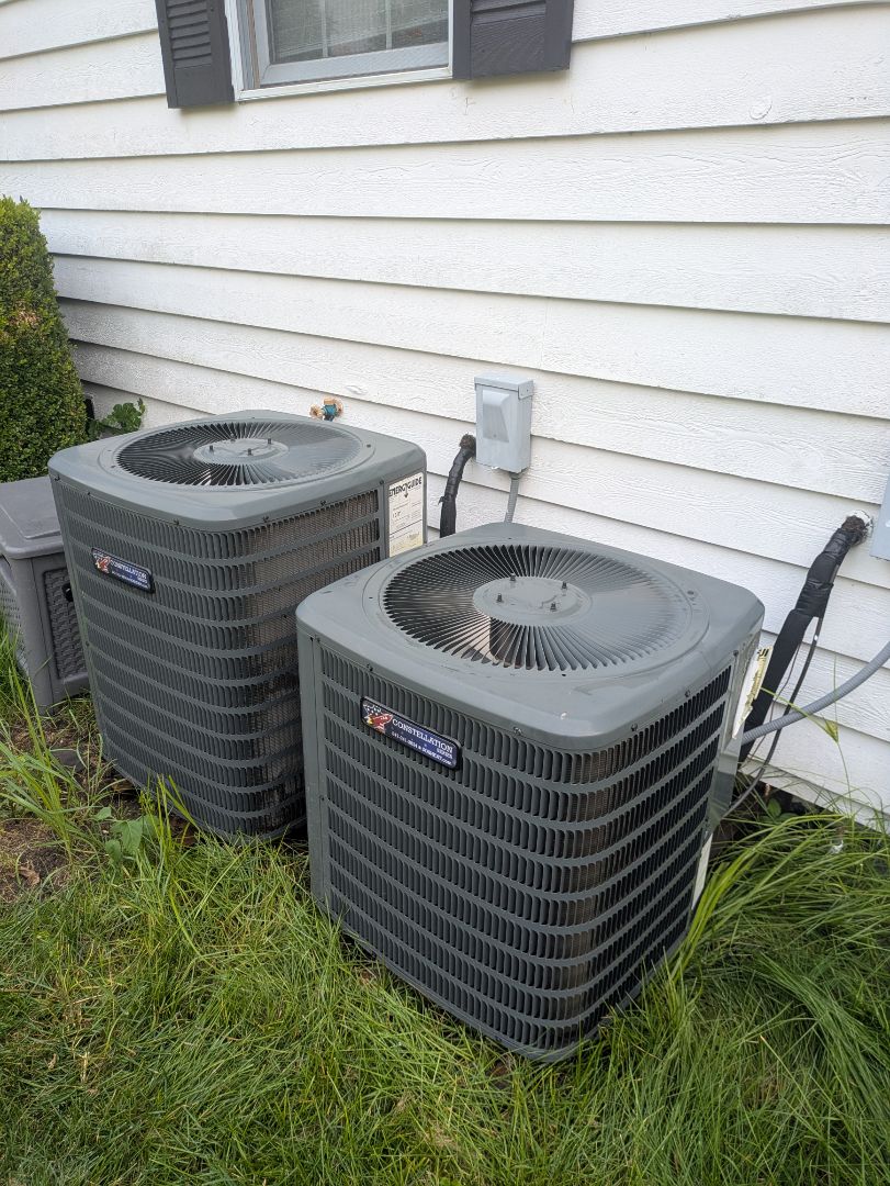 performing maintenance on two high efficiency Goodman units