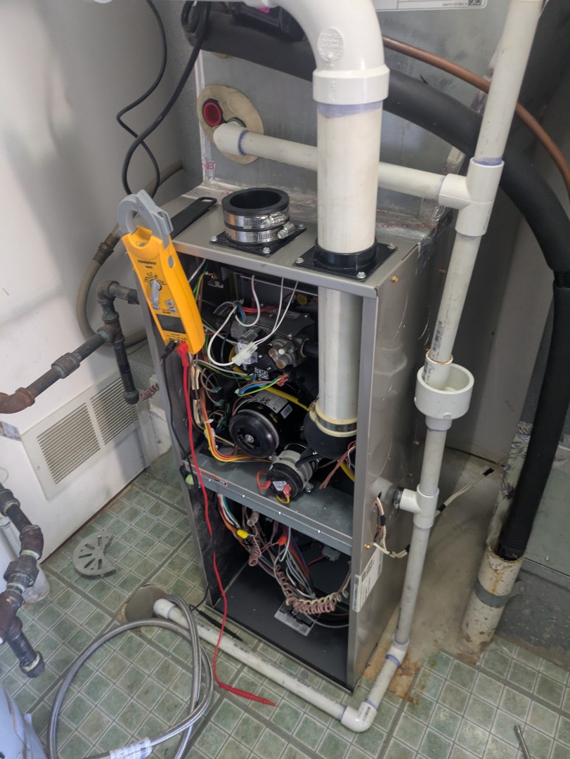 performing maintenance on a high efficiency Bryant system and flushing tank water heater 