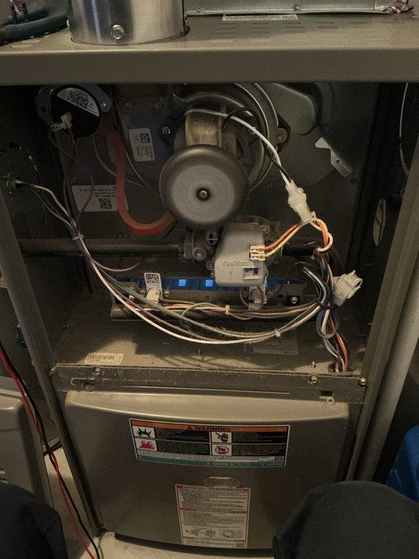 Performed scheduled Air Care Cooling and Heating maintenance service. Accessed and inspected furnace internal components including blower motor assembly, electrical connections, and control modules. Removed and examined L-shaped igniter rod and gasket material during the comprehensive system evaluation.