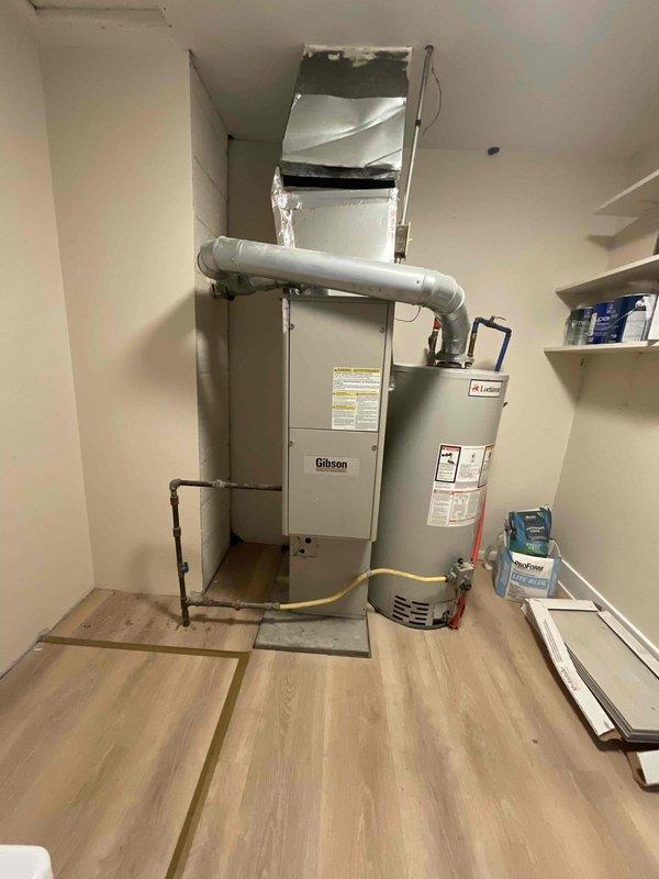 Completed inspection of residential property with existing Gibson furnace (Model KG7SA 060E-*2M) approximately 10 years old. Customer recently purchased home with forced air system and requires addition of air conditioning. Documented current installation including furnace condition, ductwork configuration, and available space in mechanical room where furnace is co-located with water heater. Provided full system estimate for AC addition to existing forced air system with customer requesting installation within next couple weeks.