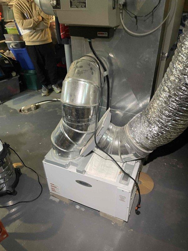 Conducted comprehensive evaluation of existing HVAC system for full replacement quote as requested by customer. Inspected current installation in basement utility room, which includes an aging furnace/air handler with complex metal ductwork configuration and flexible insulated ducting. Customer seeking complete heating, cooling, and in-home dehumidifier solutions with implementation timeline within one month.