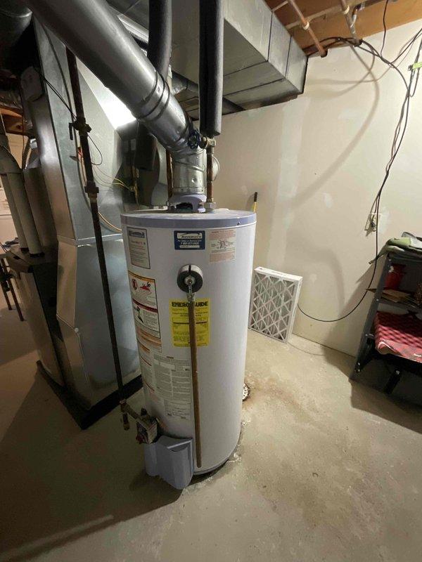 Inspected leaking 40-year-old hot water heater that has been leaking for one week in a specific area. System evaluation revealed aged tank with copper piping connections and signs of water damage. Recommended full replacement of water heater unit to resolve ongoing leak and prevent potential future failures.