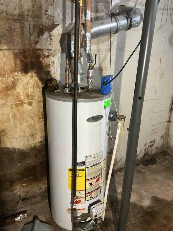 Responded to no hot water complaint where customer suspected pilot light issue. Inspected water heater in basement, examining copper pipe connections and ventilation system. No parts or labor charges applied due to service agreement coverage.