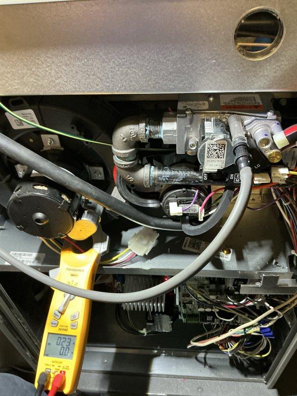 Performed routine maintenance on 1.5-year-old forced air furnace. Conducted electrical testing using multimeter (reading 0.23), inspected gas line assembly and connections, and verified proper operation of all components including circuit boards and wiring harnesses. Visual inspection confirmed system is in normal operating condition with no signs of damage, leaks, or abnormal wear.