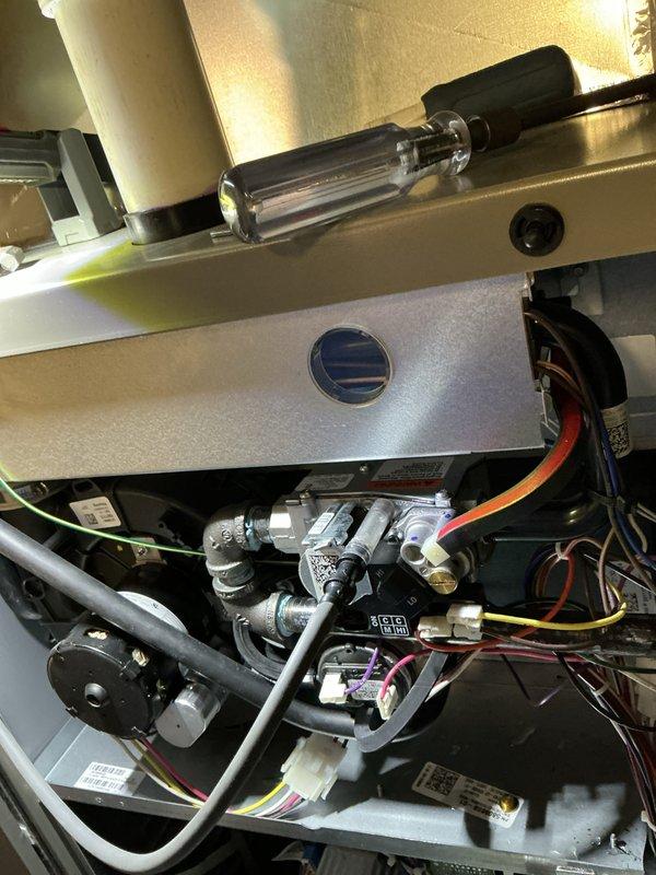 Performed routine maintenance on 1.5-year-old forced air furnace. Conducted electrical testing using multimeter (reading 0.23), inspected gas line assembly and connections, and verified proper operation of all components including circuit boards and wiring harnesses. Visual inspection confirmed system is in normal operating condition with no signs of damage, leaks, or abnormal wear.