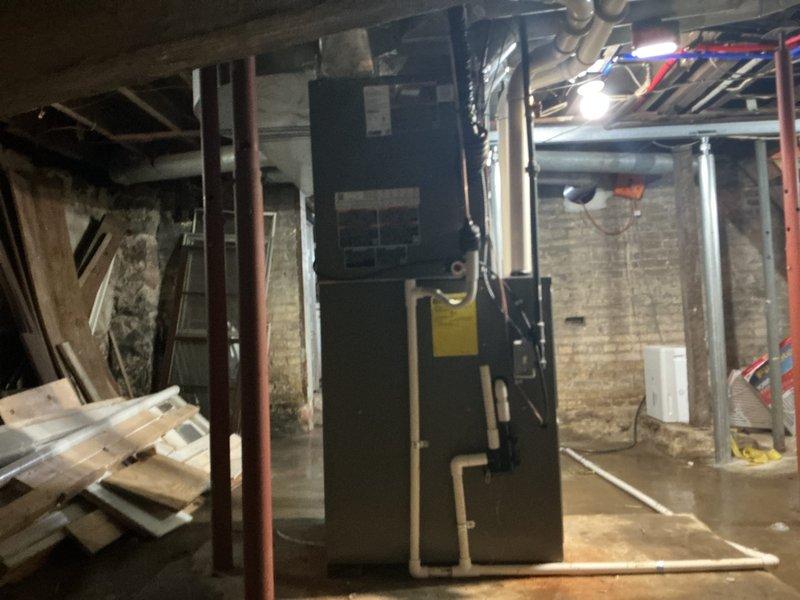 Completed installation of a new complete HVAC system consisting of a 90,000 BTU furnace and 3-ton air conditioning unit in basement location. System includes new ductwork connections, proper insulation of refrigerant lines, and installation of a dedicated electrical circuit. All mechanical and electrical permits were obtained prior to installation, with system properly mounted and connected to existing infrastructure.