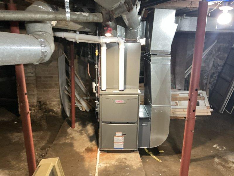 Completed installation of a new complete HVAC system consisting of a 90,000 BTU furnace and 3-ton air conditioning unit in basement location. System includes new ductwork connections, proper insulation of refrigerant lines, and installation of a dedicated electrical circuit. All mechanical and electrical permits were obtained prior to installation, with system properly mounted and connected to existing infrastructure.