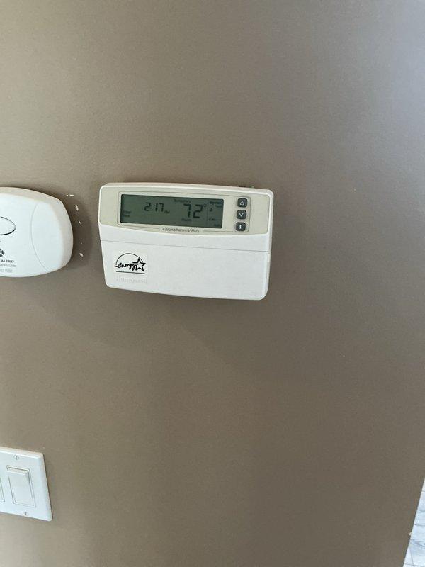 Performed annual furnace maintenance as part of customer's membership plan. Inspected thermostat operation (confirmed 72°F reading) and examined interior furnace components including gas valve, wiring harnesses, and blower assembly. System functioning properly with no issues identified; documentation photos taken of thermostat and internal components for service records.