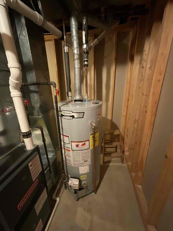 Conducted an estimate for replacement of an existing Goodman furnace and A/C system located in basement. Current equipment is operational but experiencing issues; age undetermined. Inspection revealed furnace installation includes PVC ventilation system, proper gas line connections, and integration with existing water heater system. Equipment appears to be from Q3/2019 production cycle based on visible manufacturer labeling.