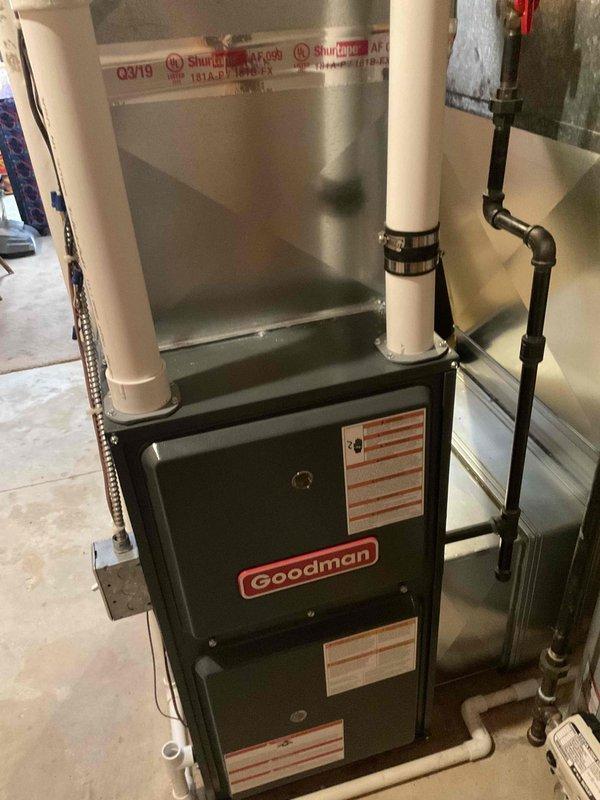 Conducted an estimate for replacement of an existing Goodman furnace and A/C system located in basement. Current equipment is operational but experiencing issues; age undetermined. Inspection revealed furnace installation includes PVC ventilation system, proper gas line connections, and integration with existing water heater system. Equipment appears to be from Q3/2019 production cycle based on visible manufacturer labeling.