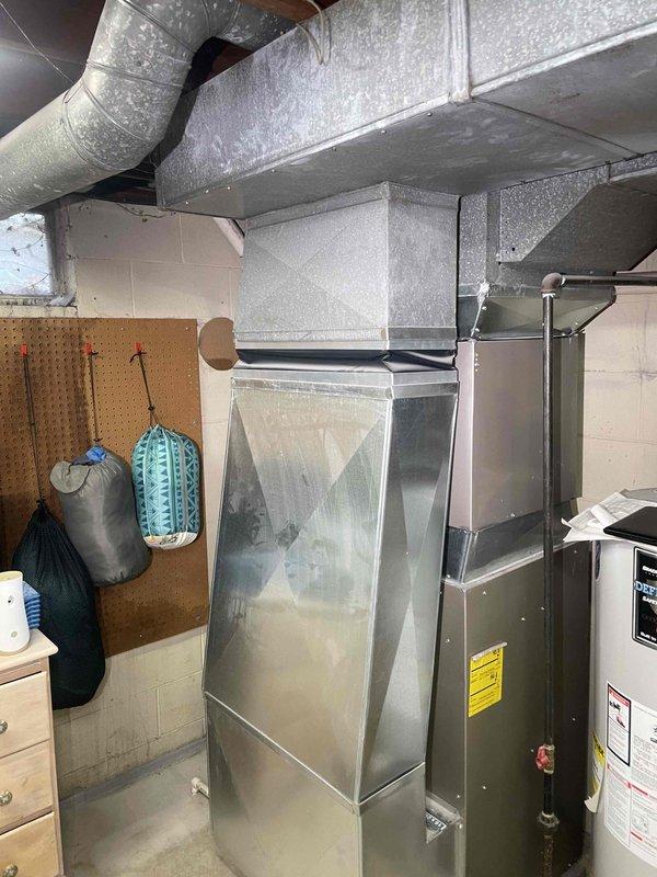Performed inspection of non-operational antiquated furnace in basement location. Documented existing HVAC system with galvanized metal ductwork and identified necessary replacement components. Containment measures were installed to protect the work area during replacement process.