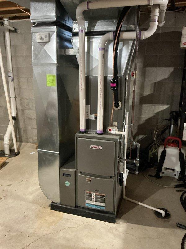 Conducted annual home maintenance service on HVAC system with pad-mounted unit and filterless design operating at approximately 10% efficiency. Inspected Lennox furnace and associated ductwork, noting significant dust accumulation on mesh filter element requiring replacement. System was operational despite expired maintenance appointment; documented condition with photographs for service record.