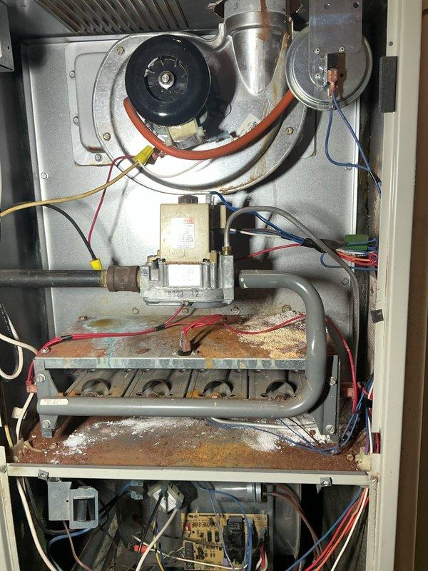 Responded to no-heat call for 30-year-old forced air system that had completely ceased operation. Upon inspection, discovered significant rust and corrosion on the heat exchanger and burner assembly, with multiple components showing advanced wear. Determined unit had reached end of serviceable life and recommended replacement due to safety concerns and inefficiency of the aging system.