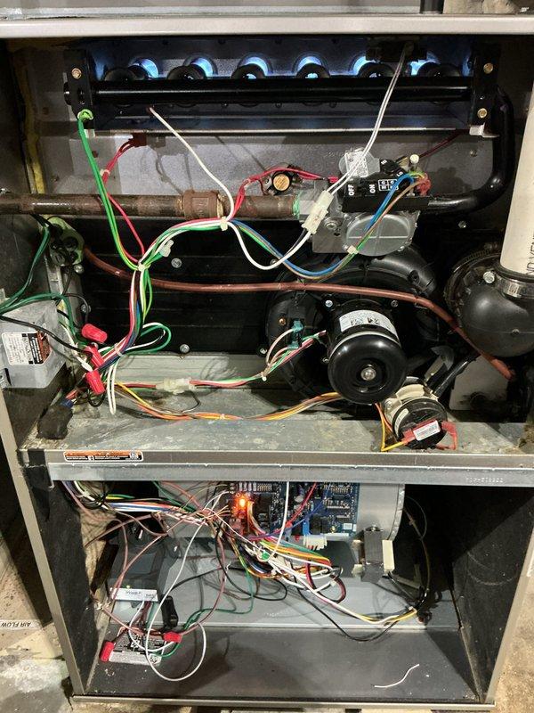 Completed routine Air Care Heating maintenance service (AHM3/1710-2) on HVAC system. Performed visual inspection of furnace interior components including motor, control boards, electrical connections, and wiring harness - all components found in normal working condition with no signs of damage or unusual wear. Inspected mechanical room configuration including water heater and associated plumbing connections.