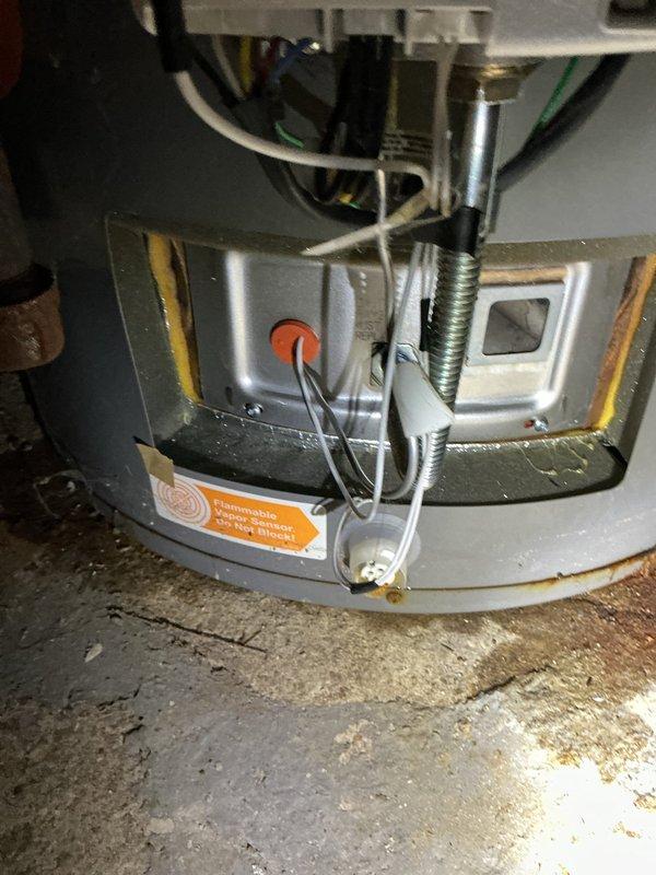 Responded to service call for non-functioning Rheem water heater (8+ years old) located in basement that would not ignite following a flood event. Upon inspection of the unit, observed potential damage to the flammable vapor ignition detection system as indicated by warning label on lower portion. Determined flood water had affected ignition components, requiring replacement of damaged parts to restore hot water service.