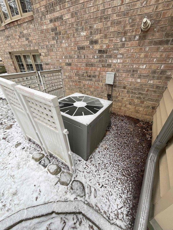 Conducted comprehensive evaluation of aging HVAC system (25-year-old natural gas furnace and AC unit) for potential replacement. Inspected basement-installed furnace with PVC exhaust venting and connected ductwork, along with outdoor AC condenser unit (protected by lattice enclosure) showing signs of age-related wear. System currently operational but approaching end of service life; replacement options presented to improve efficiency and reliability.