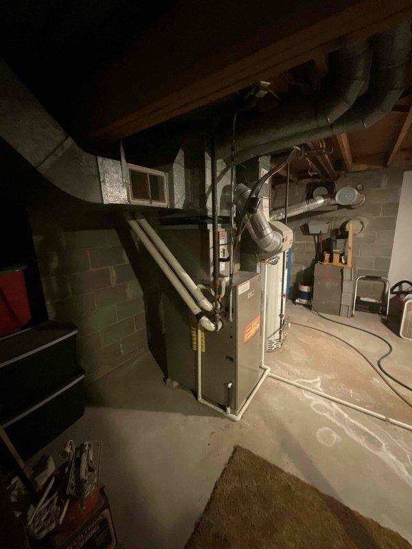 Inspected 19-year-old Bryant furnace with non-operational blower motor. System evaluation revealed end-of-life failure requiring complete replacement of the forced air furnace unit. Documented existing ductwork configuration and current installation parameters in basement mechanical room for proper sizing of replacement equipment.