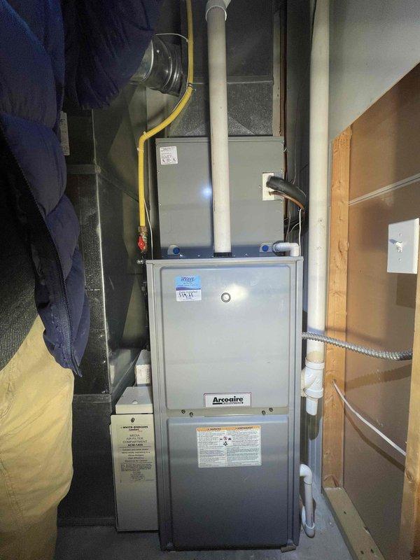 Conducted thorough evaluation of 20-year-old Arcoaire HVAC system for potential replacement. Assessment included inspection of furnace with visible gas line connection, PVC venting, and associated ductwork. Documented current system configuration and recommended full replacement of both furnace and AC components due to age and condition.