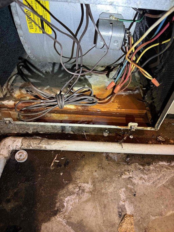 Responded to service call for a non-operational furnace over 25 years old. Upon inspection, discovered severe corrosion and rust damage on critical components, particularly affecting the base and connection points. Examination of the control wiring revealed disorganized electrical connections with potential moisture exposure concerns. Given the extensive deterioration and age of the system, recommended replacement rather than repair.
