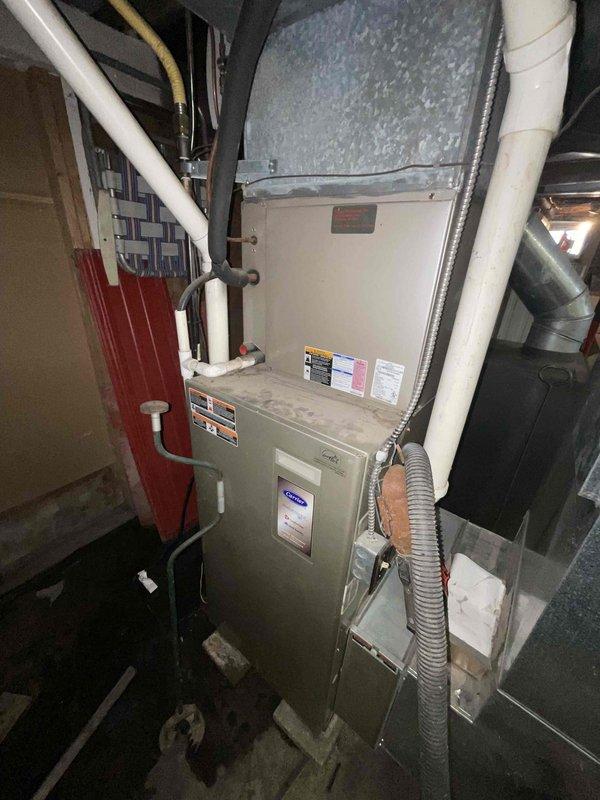 Conducted site assessment for generator installation quote at rural property with existing propane tank. Inspected current HVAC system (Carrier furnace) to evaluate integration requirements for backup power solution. Photos documented exterior utility placement and interior mechanical room configuration for comprehensive estimate preparation.