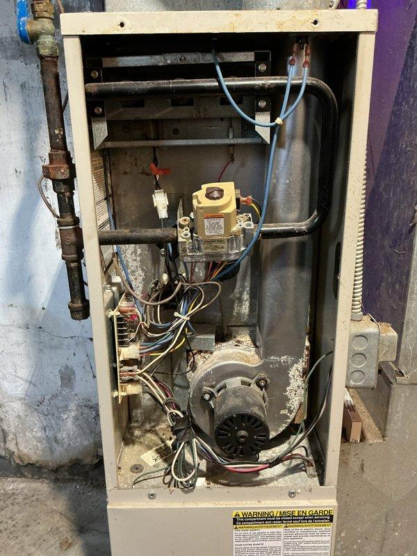 Responded to service call regarding furnace blowing cool air. Inspection revealed significant corrosion on the burner assembly with extensive rust formation on flame distributors. Removed and replaced deteriorated burners and associated components to restore proper heat generation and airflow.
