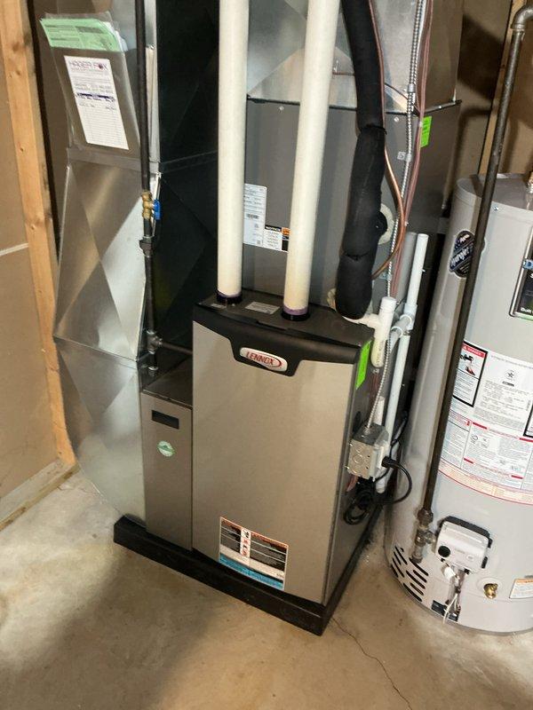 Performed ComfortGuard Maintenance Package on a Lennox HVAC system. Completed comprehensive tune-up of air handler and furnace components, confirming proper system operation. System is functioning correctly with no issues identified during the inspection; documentation photos taken of the complete installation including furnace, ductwork, and adjacent water heater for service records.