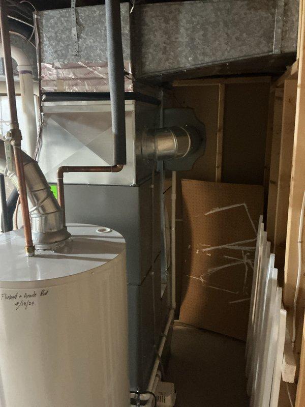 Performed ComfortGuard Maintenance Package on a Lennox HVAC system. Completed comprehensive tune-up of air handler and furnace components, confirming proper system operation. System is functioning correctly with no issues identified during the inspection; documentation photos taken of the complete installation including furnace, ductwork, and adjacent water heater for service records.