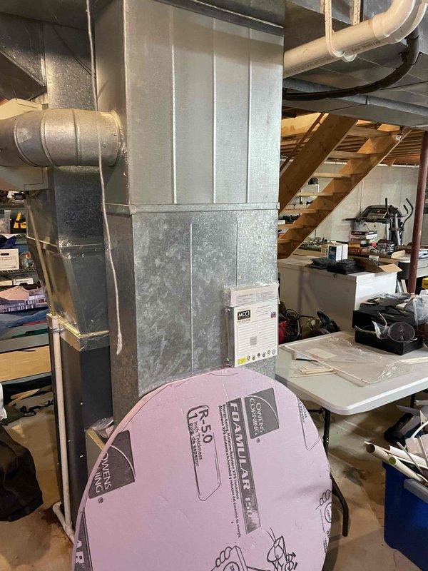 Completed Home Show appointment evaluation of existing A/C system. Inspected aging air handler unit installed in basement with visible wear on lower panels. Documented current setup including galvanized ductwork connections, condensate drainage system, and R-5.0 insulation. Photos taken of complete system for replacement estimate preparation.