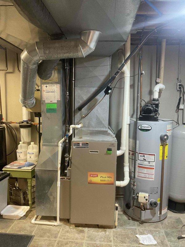 Performed inspection of existing Bryant Plus 95x furnace in no-heat situation. System is a forced air setup with standard ductwork configuration and appears to be installed in utility room alongside Smith water heater. Recommended complete furnace replacement with option for BOGO (Buy One Get One) on AC unit. Customer considering replacement options for aging system that's currently non-operational.
