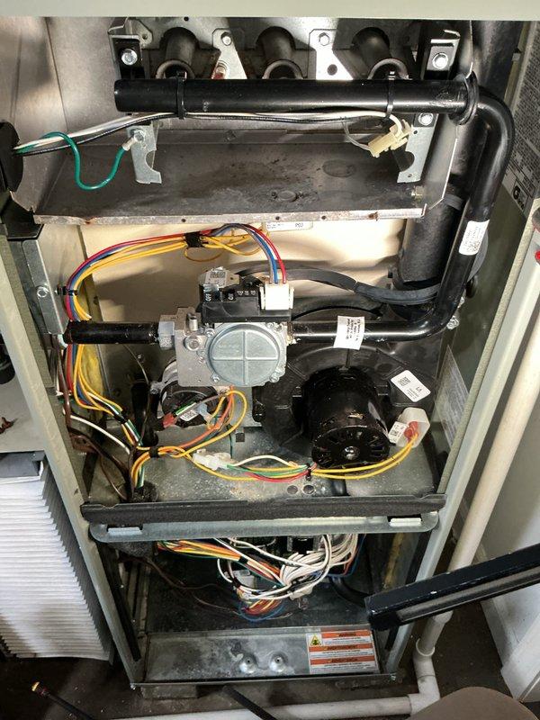 Performed comprehensive furnace tune-up on forced air system that was non-operational. Accessed internal components, inspected and cleaned blower assembly using specialized cleaning tools. Installed new humidifier as requested, verifying proper electrical connections to control board and ensuring all wiring (yellow, red, green, white) was correctly secured. System restored to proper working condition with both heating and humidity control functions operational.