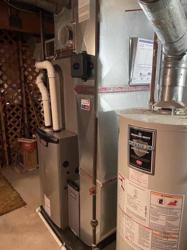 Completed installation of a complete HVAC system including a 70,000 BTU furnace and 2-ton AC unit with proper mechanical permits. System was installed on the left side of the utility room with new PVC venting, and all necessary ductwork was properly connected to the existing distribution system.