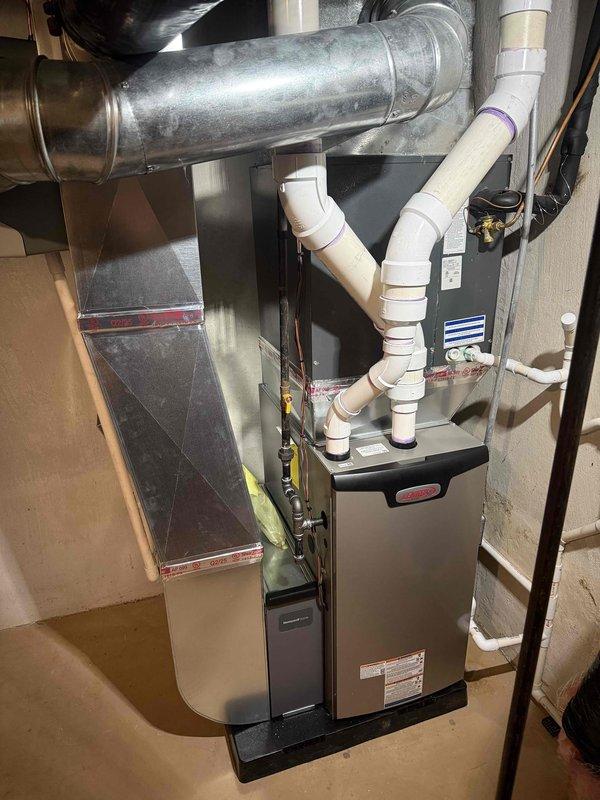 Successfully completed installation of a 70,000 BTU furnace with complete reconnection of existing ductwork. System includes proper PVC venting and condensate drainage lines with all manufacturer specifications met and tested for optimal performance.