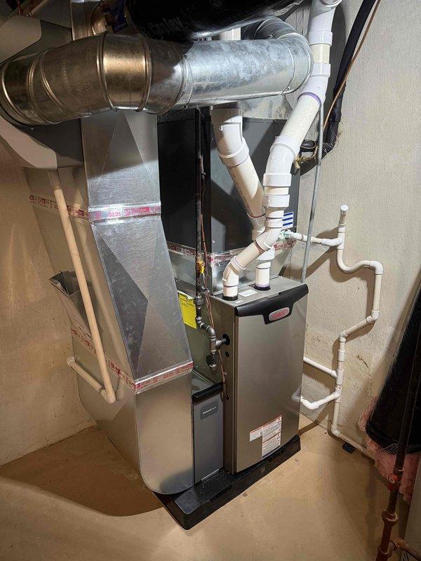 Successfully completed installation of a 70,000 BTU furnace with complete reconnection of existing ductwork. System includes proper PVC venting and condensate drainage lines with all manufacturer specifications met and tested for optimal performance.