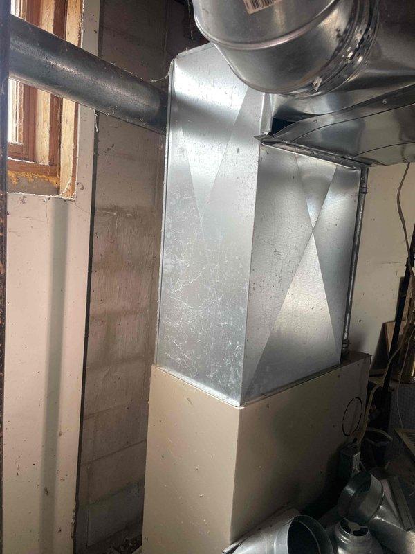 Conducted inspection on 12-year-old Lennox furnace reporting ignition failure. Diagnosed non-functioning burner assembly while blower motor remains operational. Recommended full system replacement due to age and condition, noting existing ductwork requires modifications to accommodate new equipment. Photos documented current installation configuration in basement utility area.