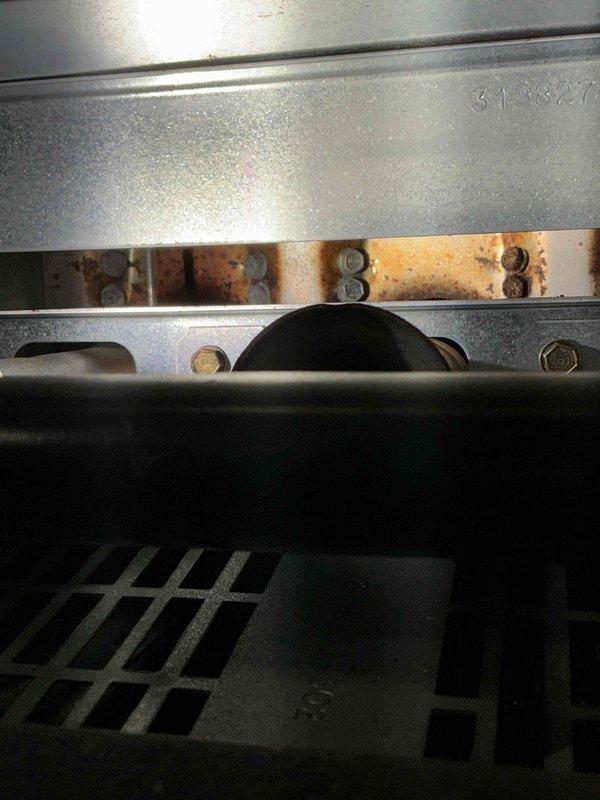 Performed tune-up service on Bryant gas furnace. Discovered significant rust and corrosion around the heat exchanger and drainage components. Cleaned clogged condensate line to restore proper drainage and addressed startup noise by lubricating moving parts and securing loose components.