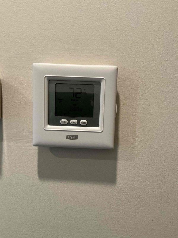 Successfully installed new Emerson Sensi programmable thermostat, replacing existing Bryant unit. Verified proper functionality with temperature reading of 74°F and confirmed all programmable features (home/away/sleep modes) were operational.