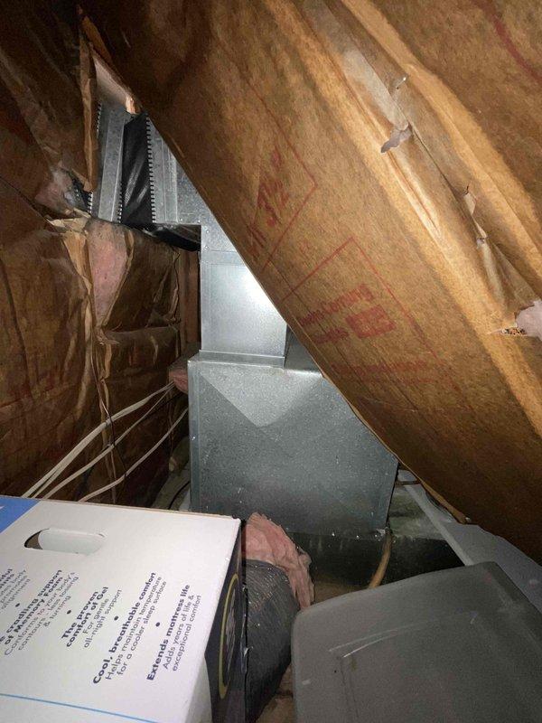 Completed evaluation of existing HVAC system in attic space for double furnace and air conditioning replacement. Documented current installation showing metal plenum connections, flexible insulated ducting, and surrounding fiberglass insulation. Assessment performed as part of home show quote #126418-01 and #126420-01 for complete system upgrade.