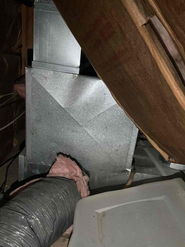 Completed evaluation of existing HVAC system in attic space for double furnace and air conditioning replacement. Documented current installation showing metal plenum connections, flexible insulated ducting, and surrounding fiberglass insulation. Assessment performed as part of home show quote #126418-01 and #126420-01 for complete system upgrade.