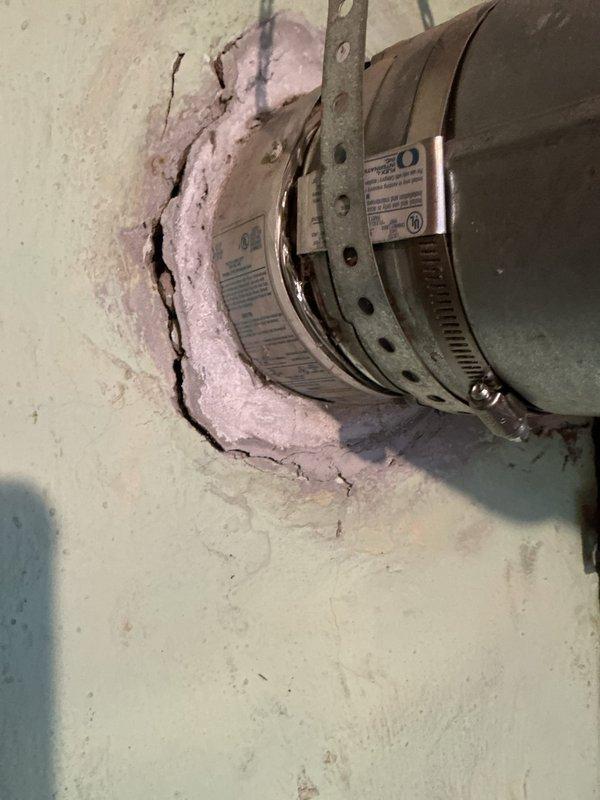 Completed annual heating maintenance on customer's furnace under Air Care membership. Inspected gas valve assembly and associated electrical connections, finding all components in proper working order. Noted wall deterioration around vent pipe penetration with exposed insulation that should be sealed to prevent further damage and maintain system efficiency.