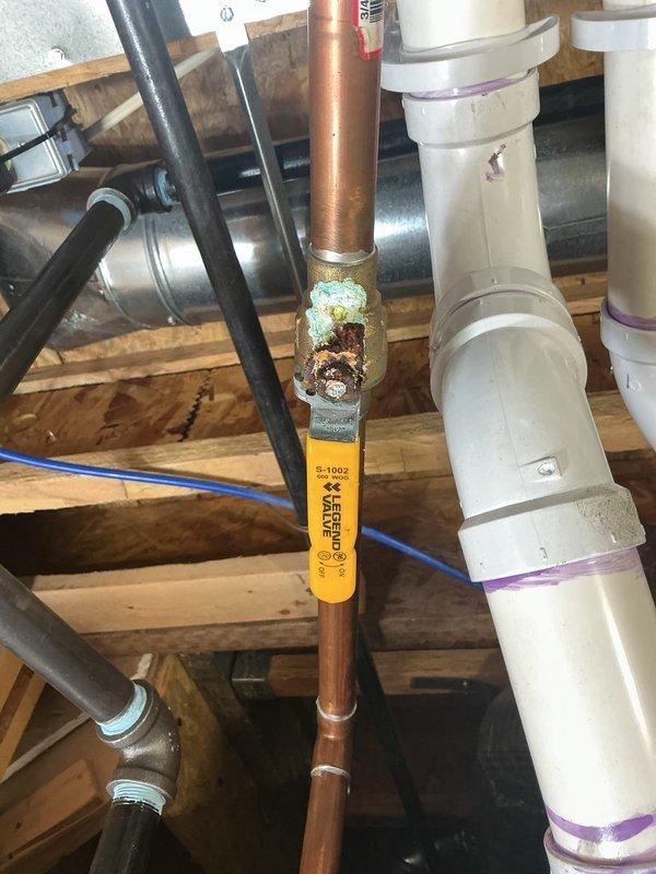 Diagnosed warranty-covered tankless water heater installed in 2022 that exhibited leakage and calcium buildup. Inspection revealed significant corrosion and mineral deposits at copper pipe joints connecting to the unit, particularly at brass fittings where advanced oxidation had formed. Cleaned affected components and replaced damaged copper pipe section to resolve the leak.