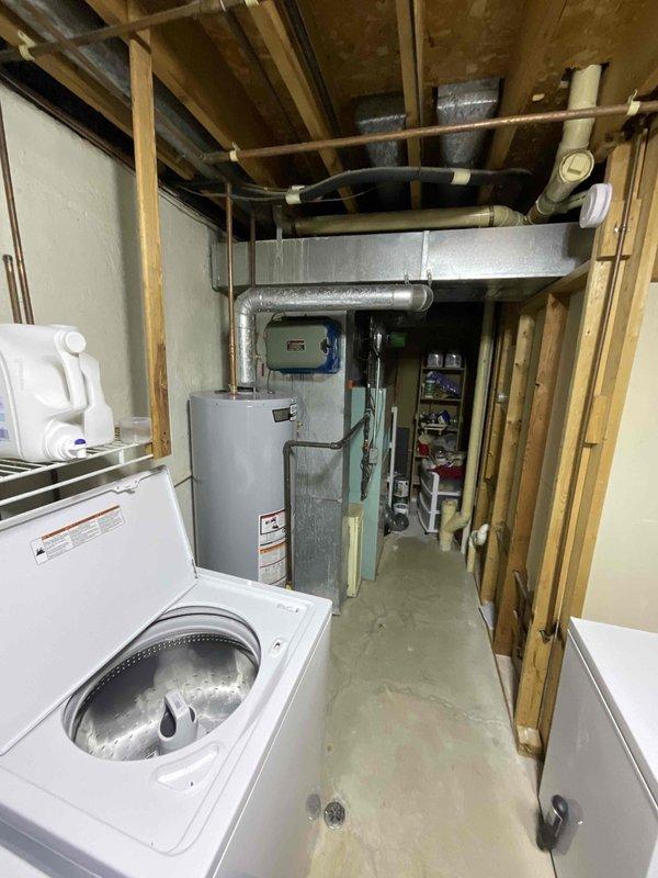 Conducted comprehensive assessment of residential HVAC system in unfinished basement utility area. Evaluated existing furnace unit, ductwork configuration, and available space for full system replacement. Documented current installation including metal rectangular ducts, insulated piping, and associated PVC venting for quote preparation.